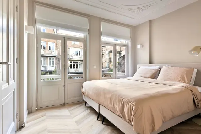 Double bedroom with balcony doors at Splendom Vondelpark