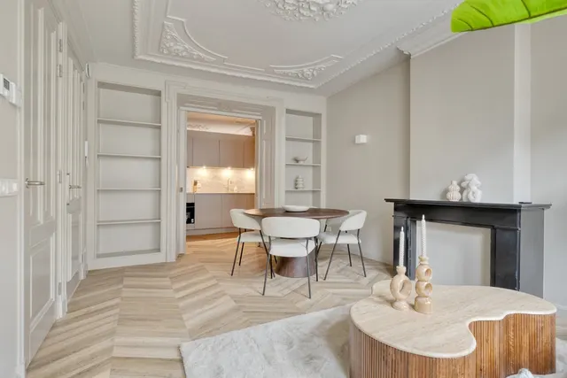 Living and dining area with period details at Splendom Vondelpark