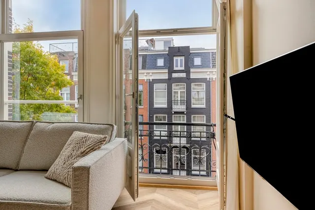 Living area with front balcony doors at Splendom Vondelpark